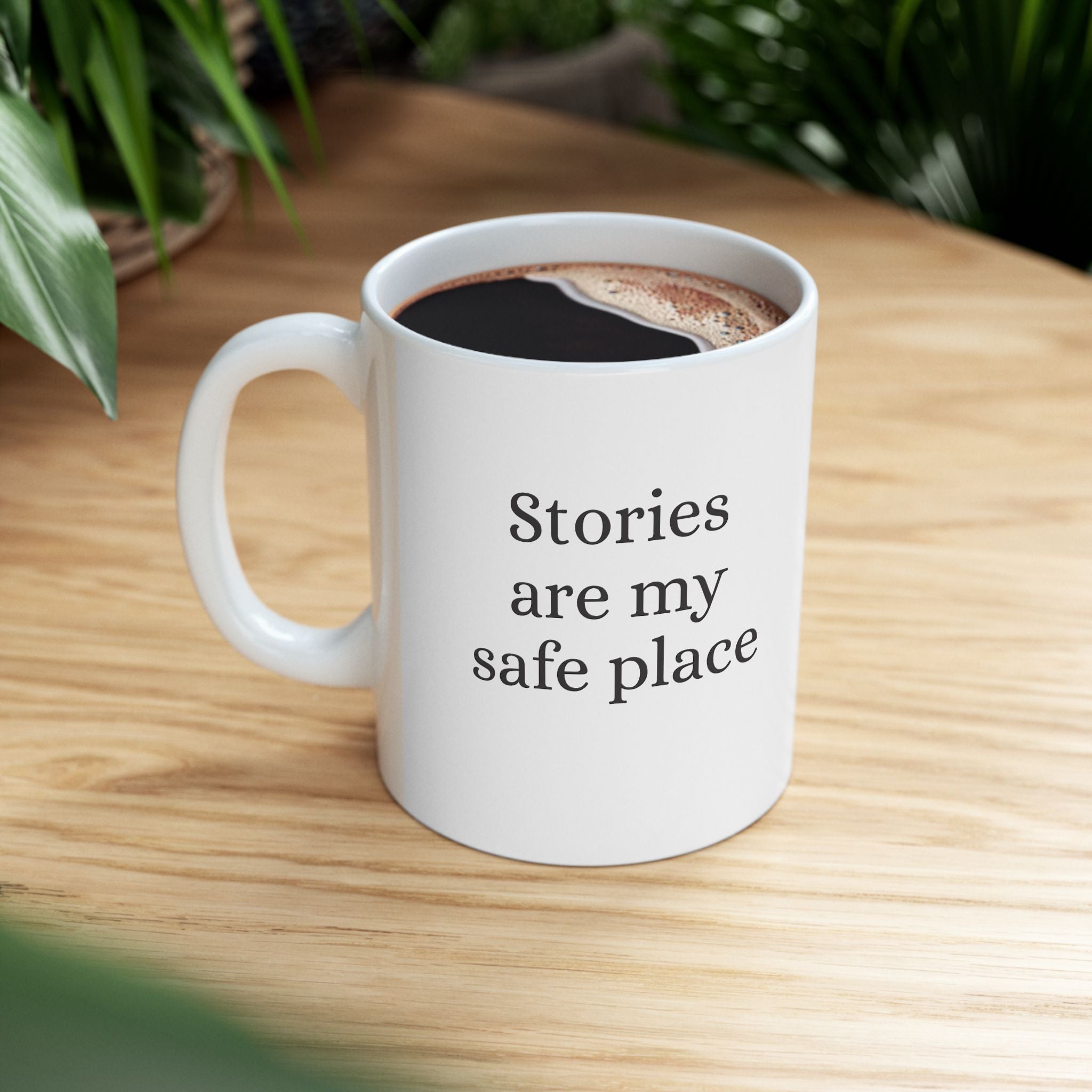 Ceramic mug featuring "Stories are my safe place" quote, ideal for book lovers, with a stylish design and comfortable handle.