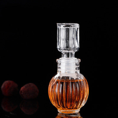 Three vintage-style mini glass wishing bottles with cork stoppers, decorative decanter-inspired apothecary jars.