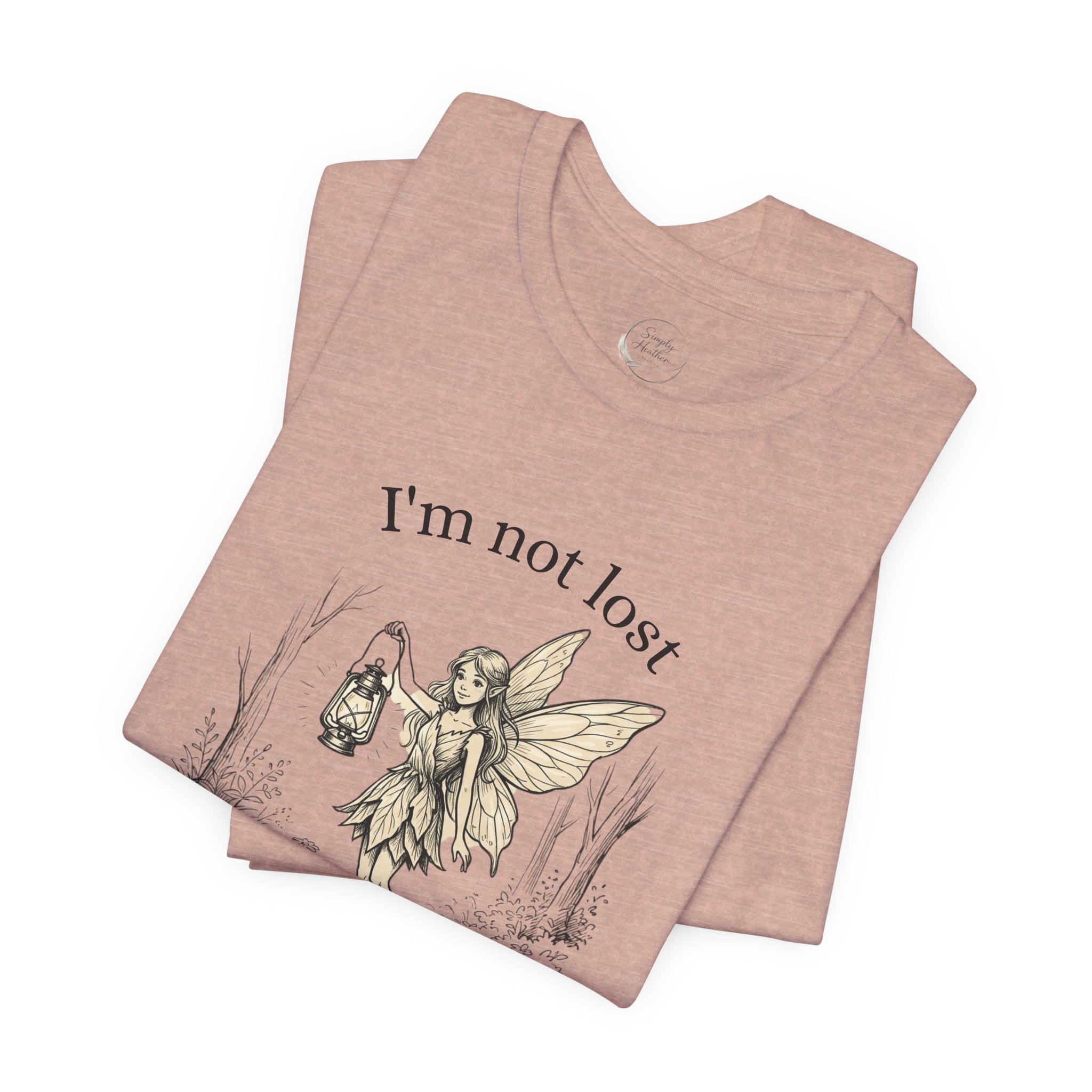 Fairy Exploration Tee by Printify featuring a graphic of a fairy and the text “I’m Not Lost, I’m Exploring” on a casual T-shirt.