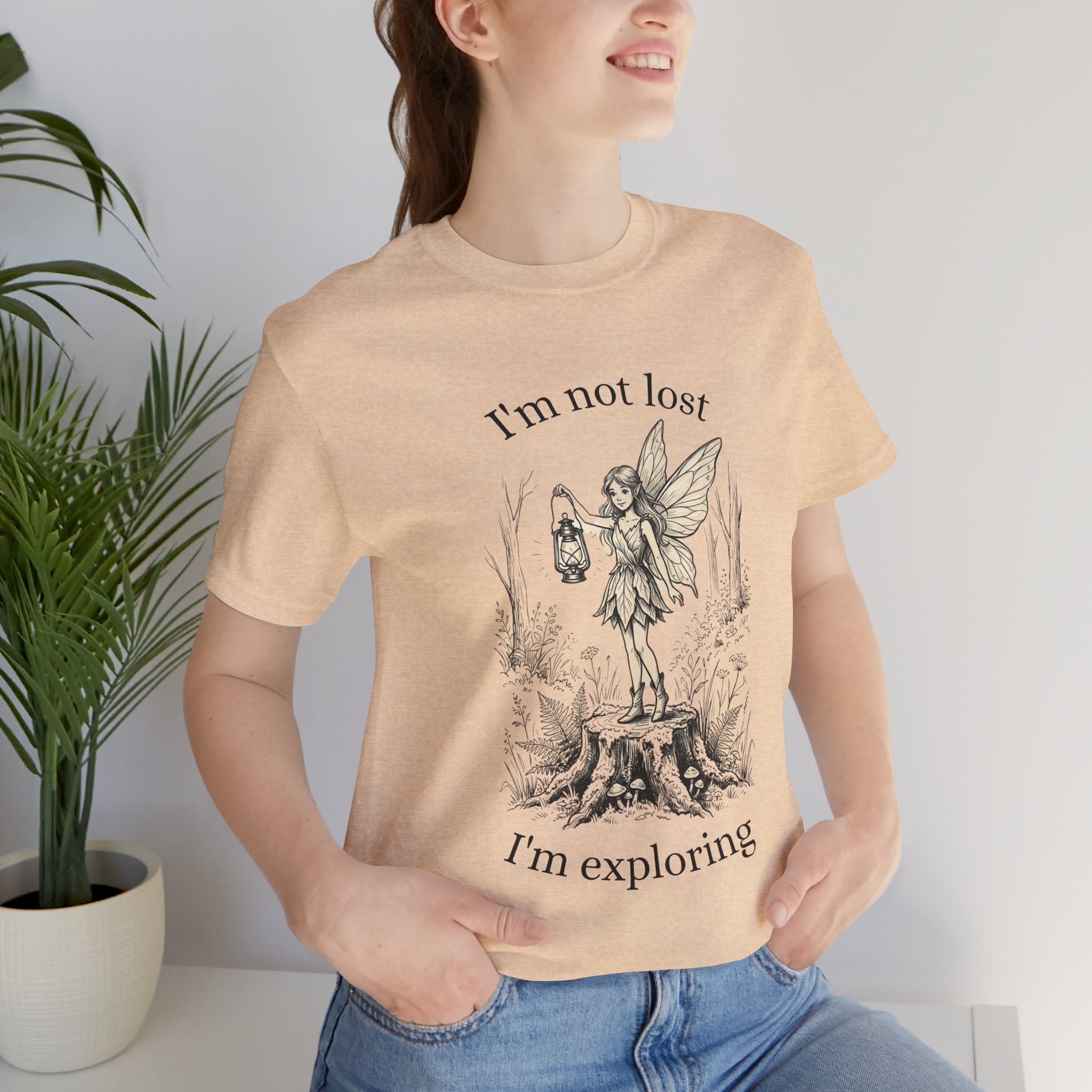 Fairy Exploration Tee by Printify featuring a graphic design with the phrase "I’m Not Lost, I’m Exploring" on a casual T-shirt.
