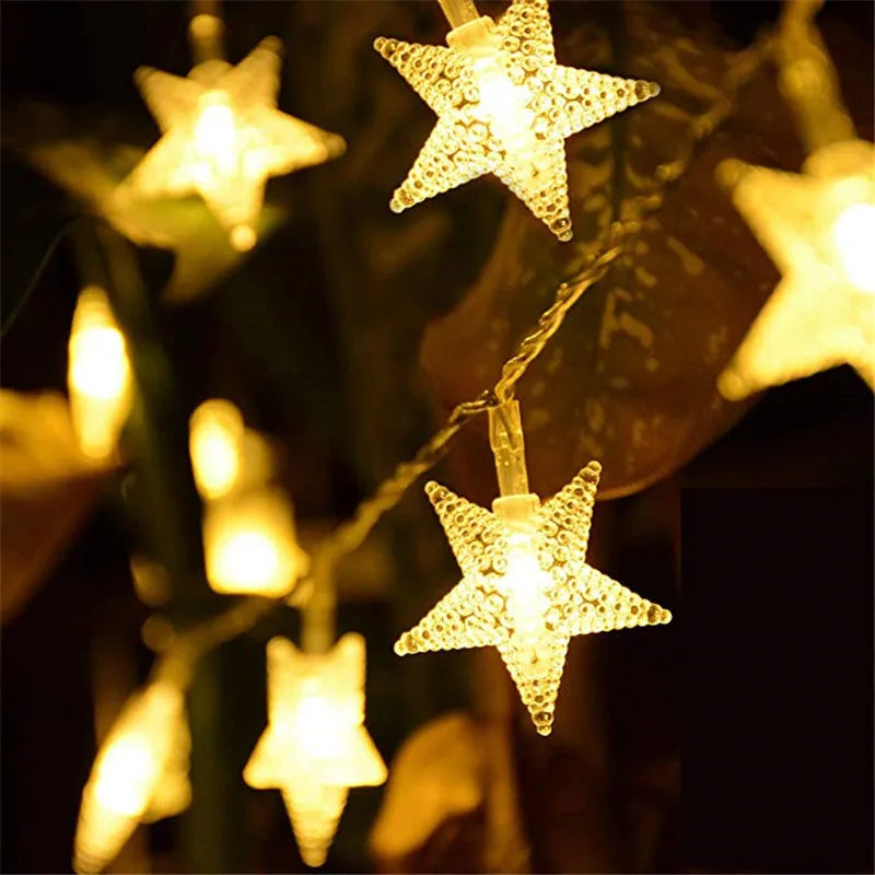 Close-up of Hollowpath Startrail LED fairy string lights with star-shaped bulbs emitting a soft enchanted glow.