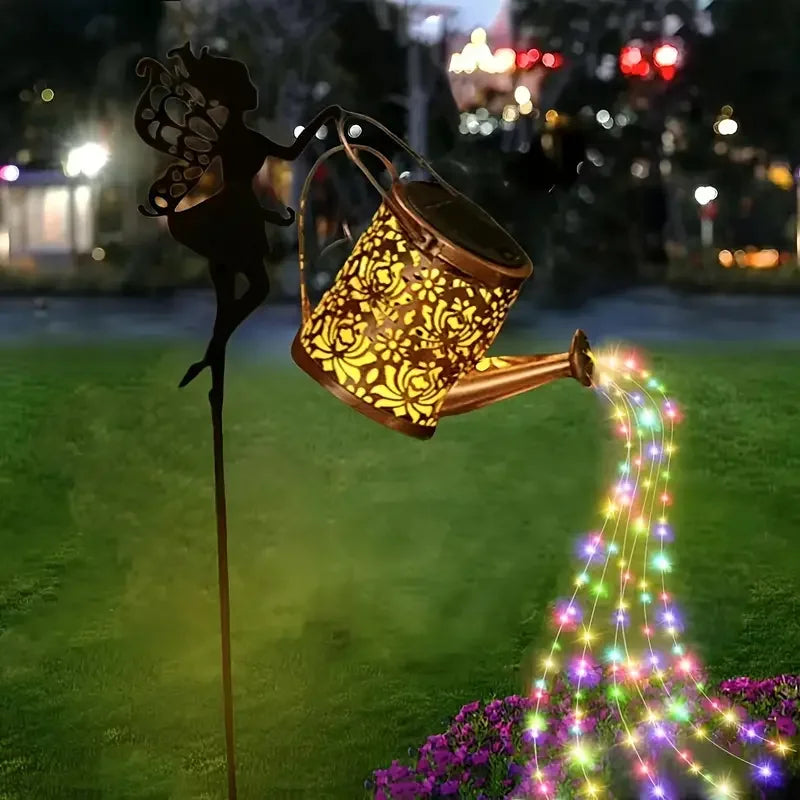 Colorful fairy watering can garden light by Simply Heather Creative, illuminated with multicolor LED, perfect as enchanted yard ornament.