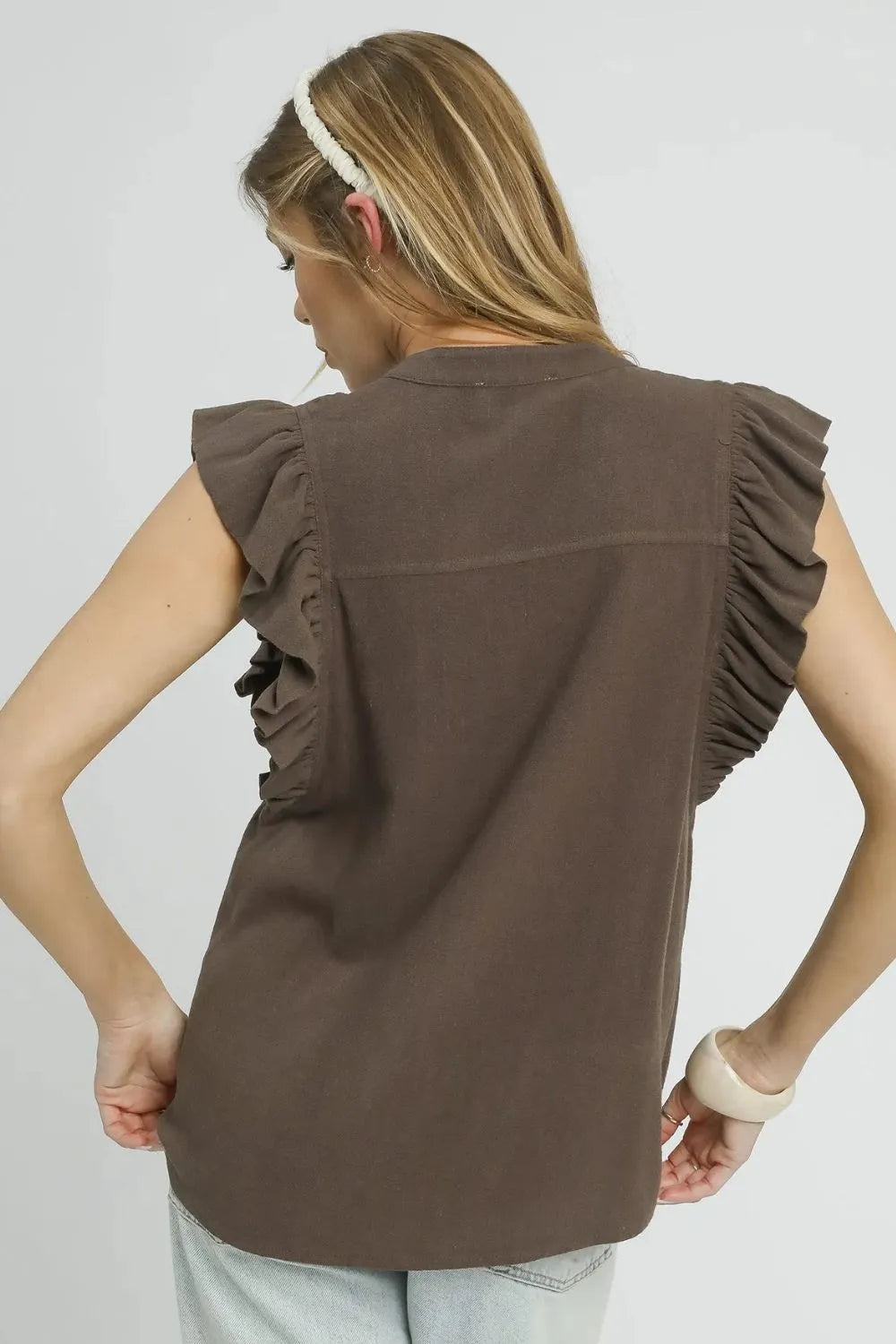 Back view of a linen ruffle sleeve button-down blouse from Trendsi, featuring a relaxed woodland cottage style.