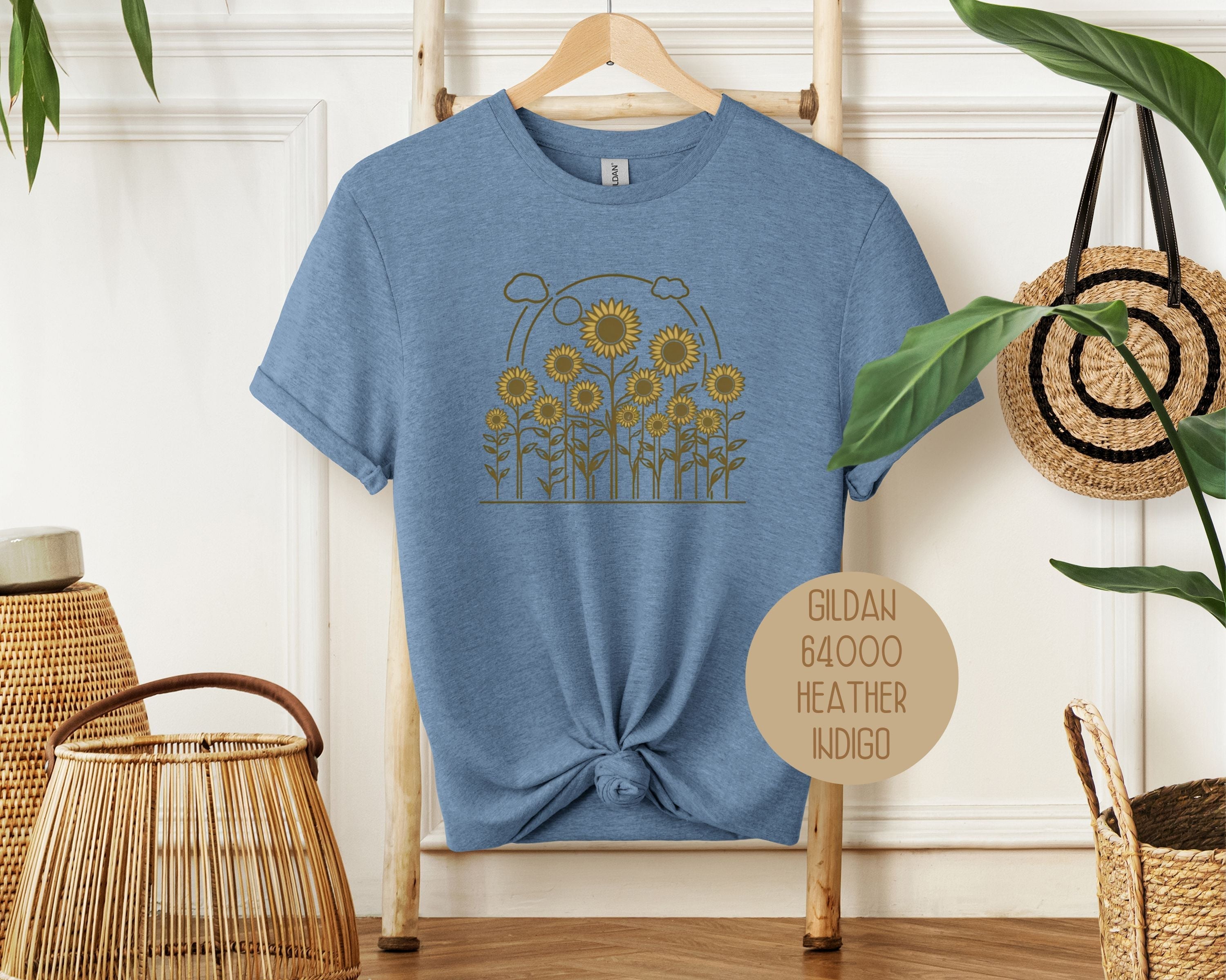 Heather indigo Rosehaven Cottage vintage sunflower T-shirt by CreativeSpecialTs, featuring a sunflower design on the front.