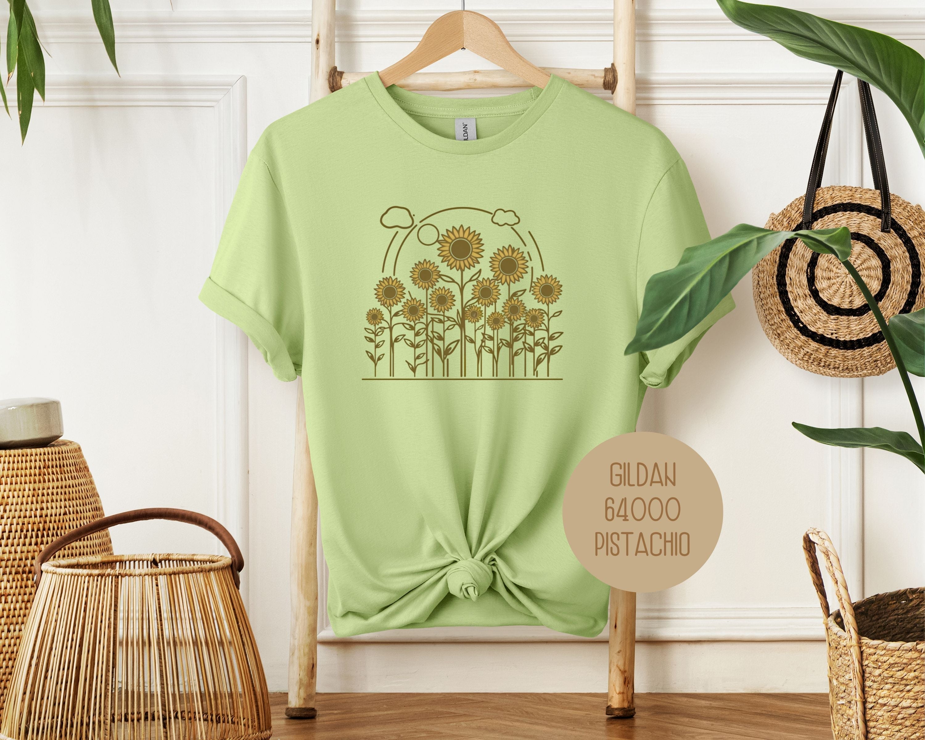 Cream-colored Rosehaven Cottage vintage sunflower T-shirt by CreativeSpecialTs, featuring a front view of a sunflower design.