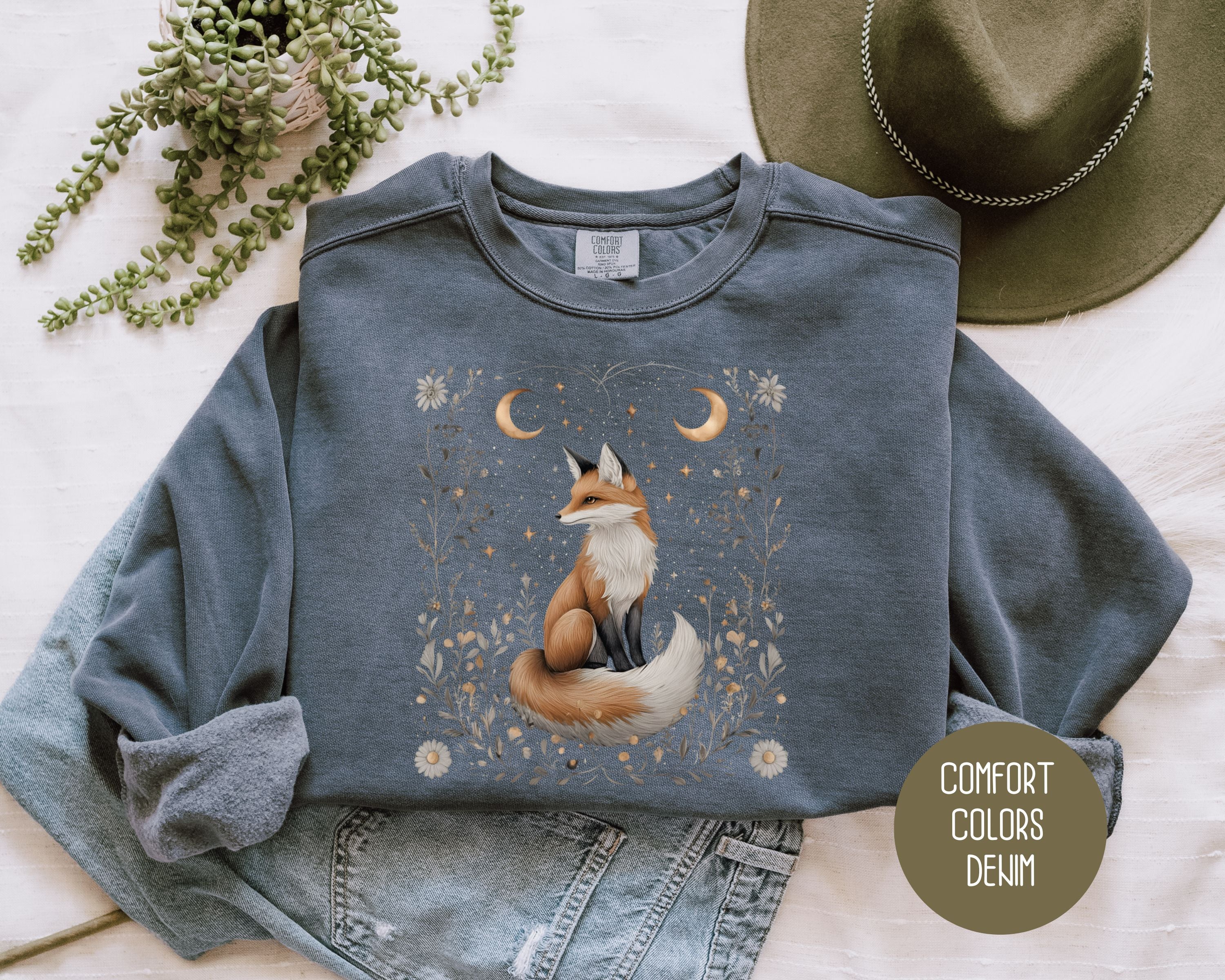 CreativeSpecialTs celestial fox sweatshirt featuring a starlit hollow fox design on denim-colored Comfort Colors fabric, front view.