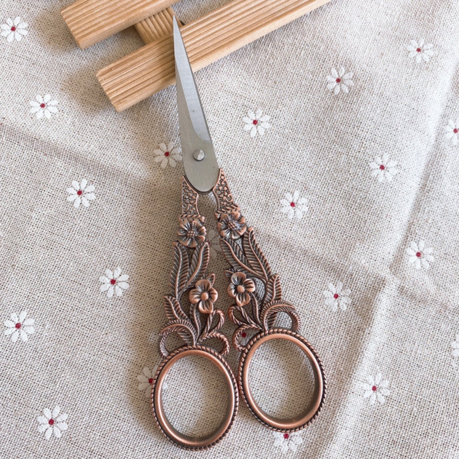 Vintage copper daffodil embroidery scissors by 24 Hour Crafts with ornate floral design, perfect for crafting and sewing projects.