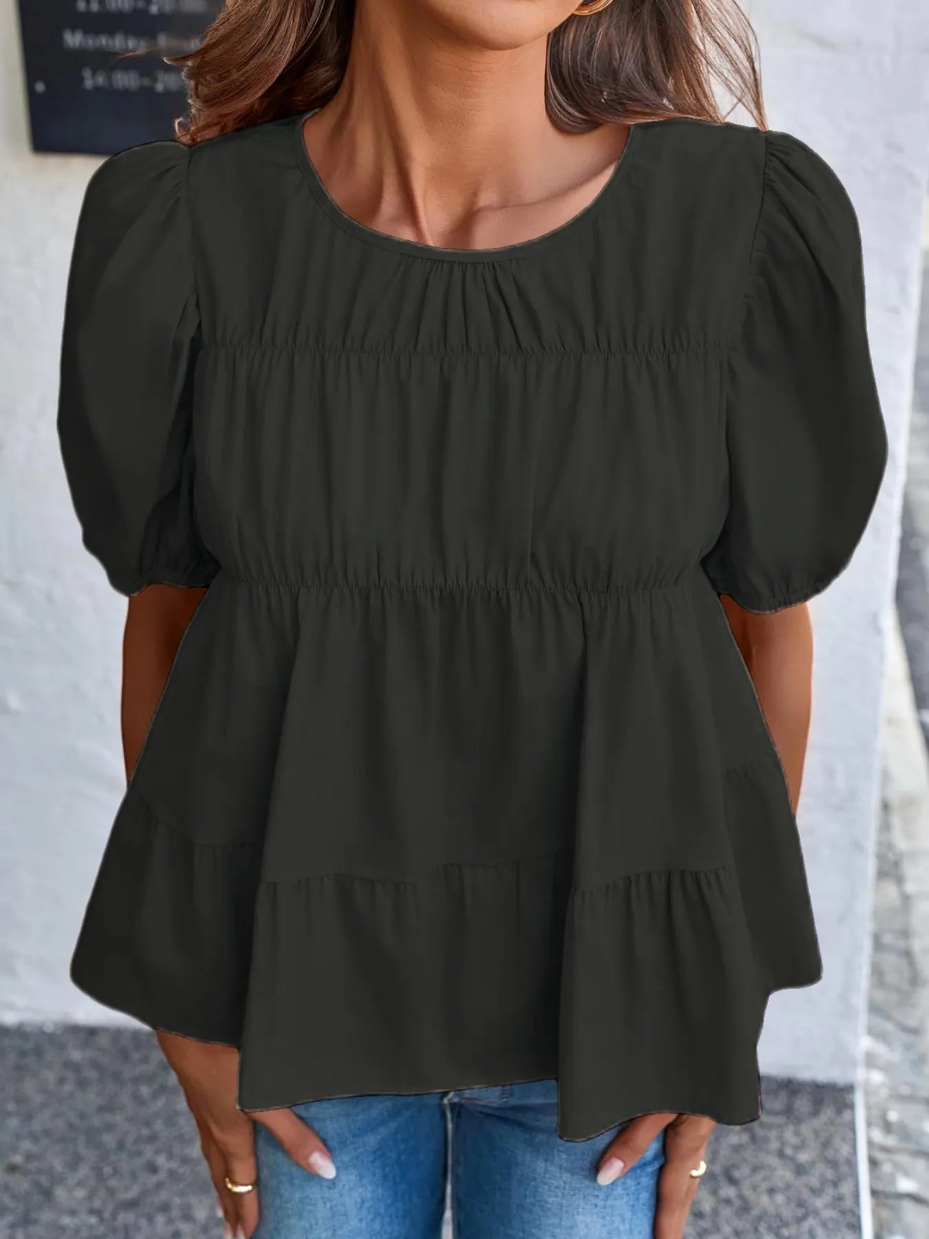 Soft meadow-colored puff sleeve tiered cottage blouse by Trendsi, featuring a feminine silhouette and delicate fabric details.