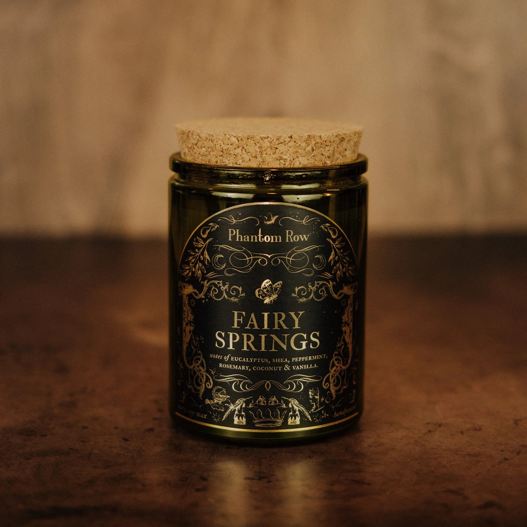 Phantom Row Fairy Springs Candle with a decorative glass holder and floral design, perfect for ambient home decor.