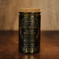Tall Fairy Springs Candle by Phantom Row featuring a sleek design and a soft, glowing flame in a minimalistic setting.