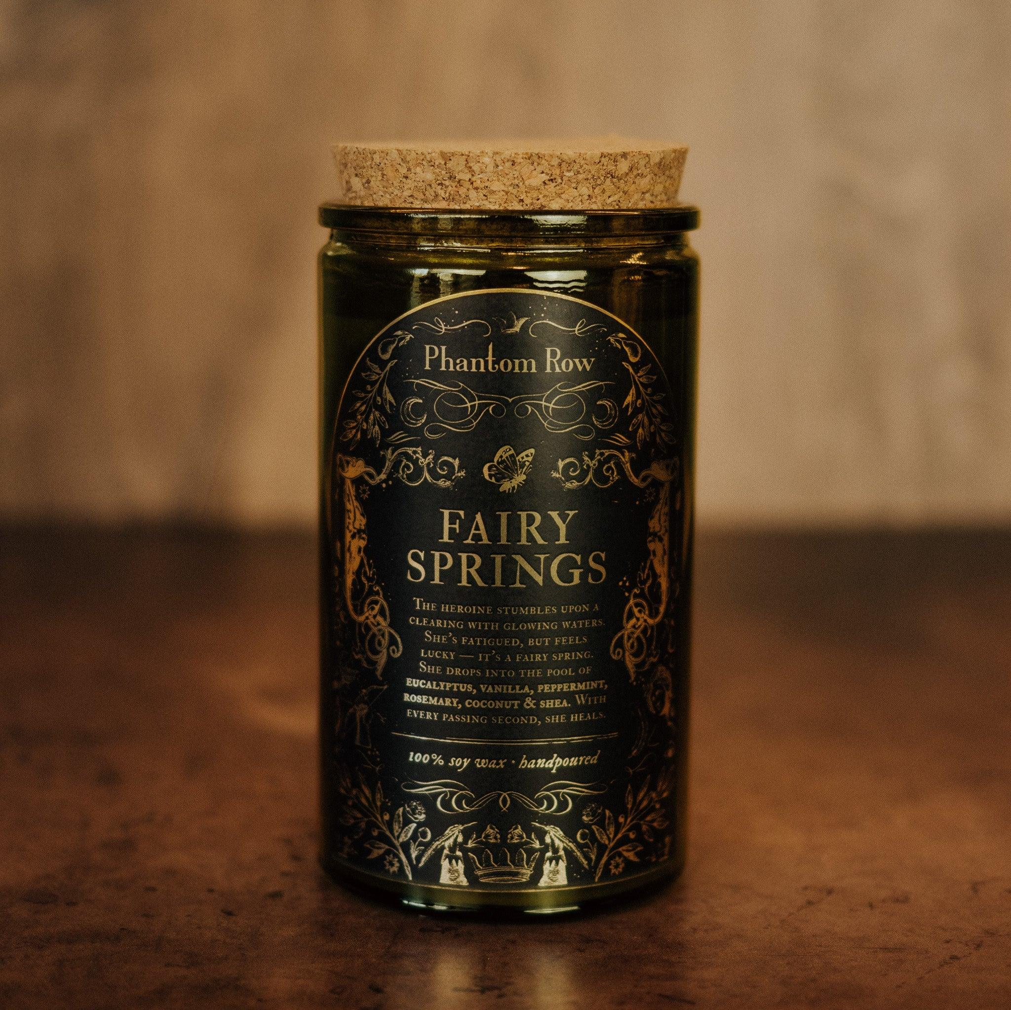 Tall Fairy Springs Candle by Phantom Row featuring a sleek design and a soft, glowing flame in a minimalistic setting.