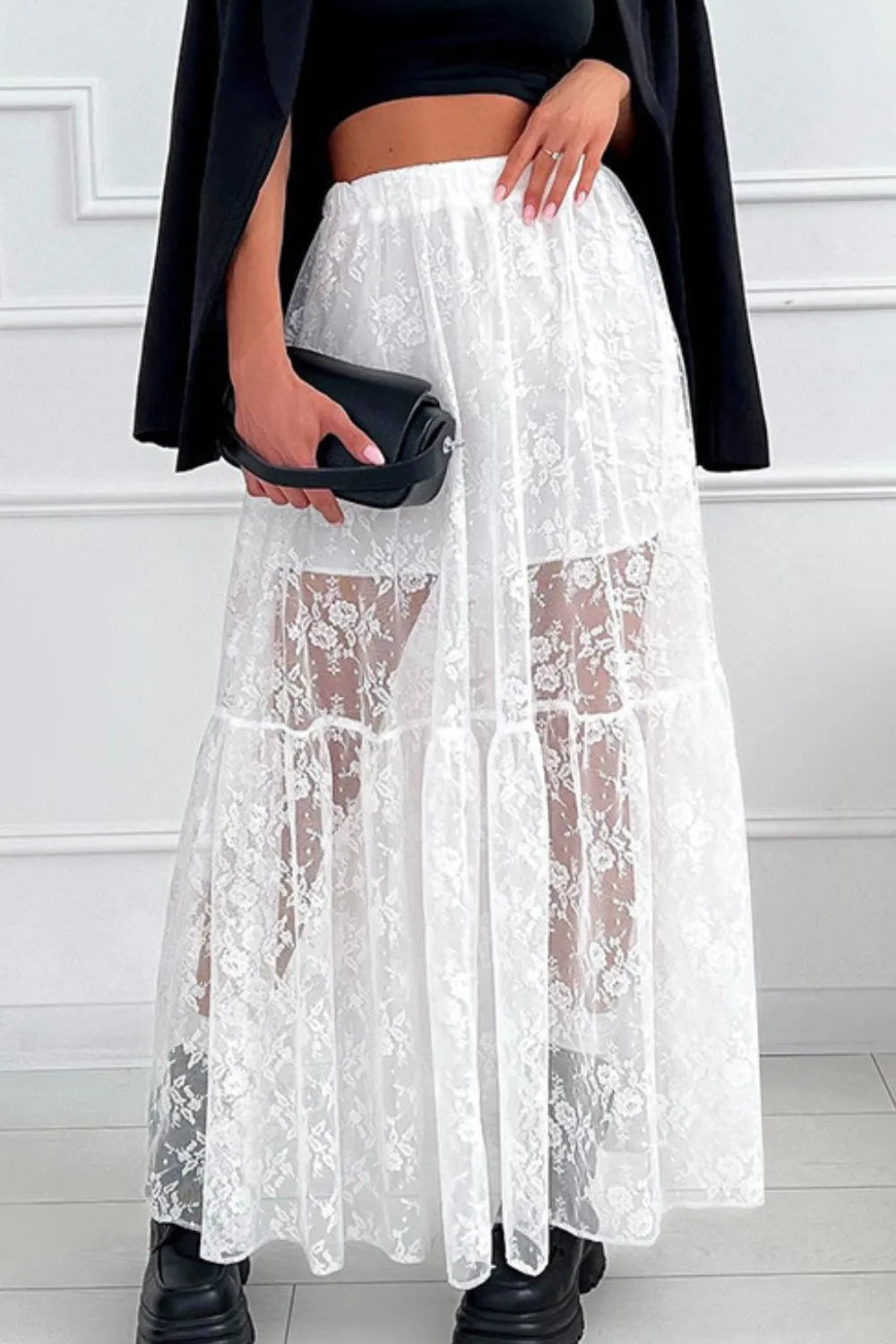 White lace maxi skirt with elastic waistband, lined body, and semi-sheer lace overlay, perfect for elegant, boho-inspired looks.