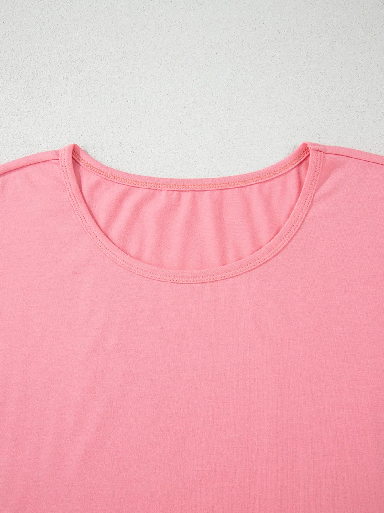 Pale blush ruffle hem cottage tee by Trendsi featuring a round neckline and soft fabric, casual and feminine T-shirt style.