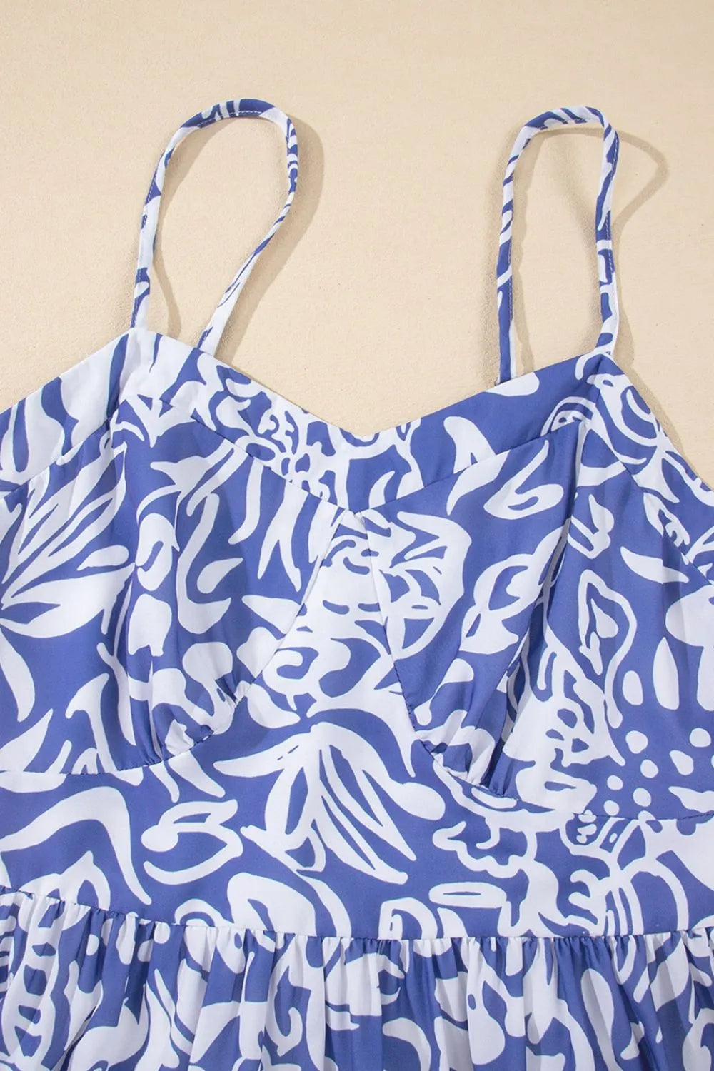 Bluebell Reverie sundress by Trendsi with spaghetti straps, front close-up showing whimsical floral print and lightweight fabric.