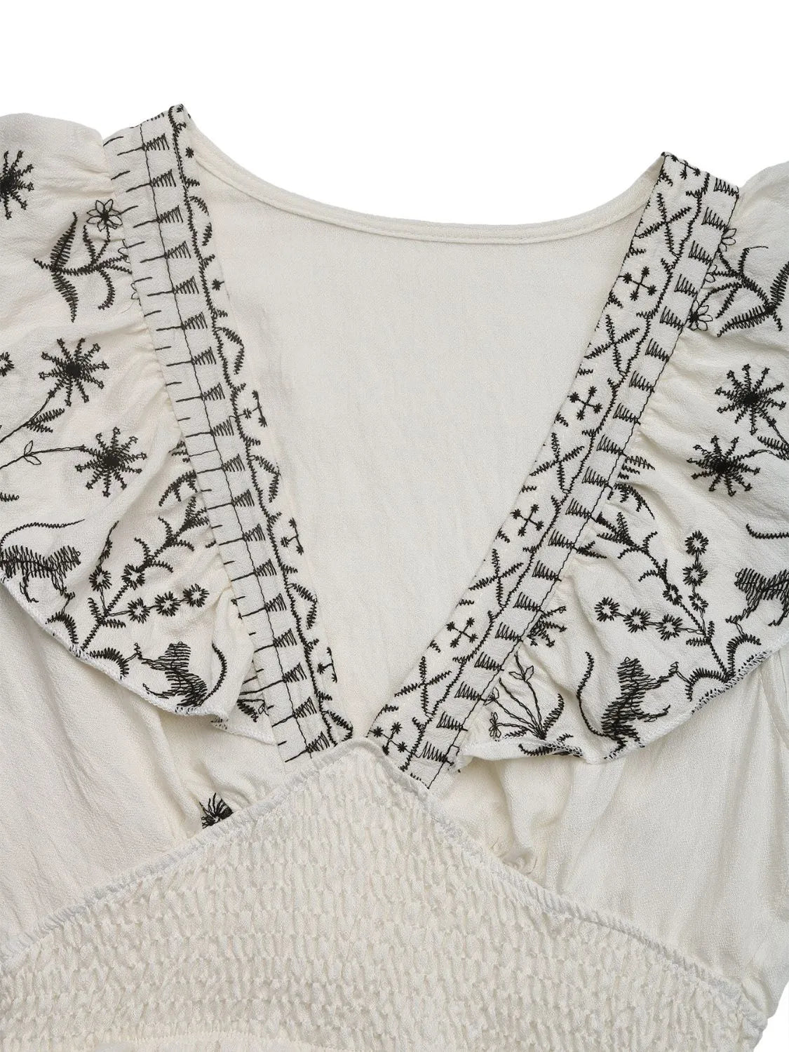 Cream Woodland Muse smocked mini dress with V-neck detail, featuring a fitted silhouette and delicate fabric.
