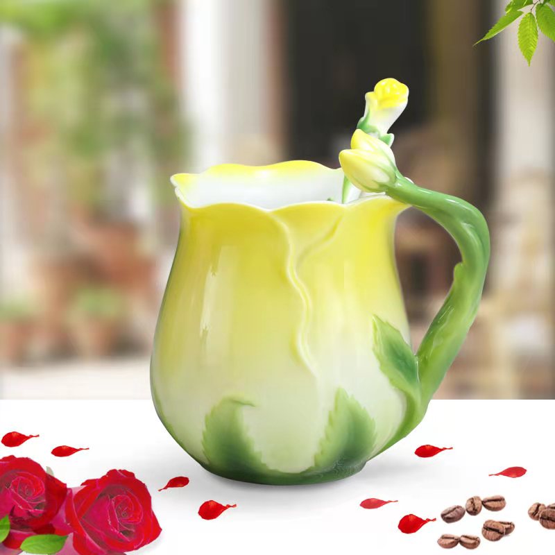 Yellow vintage rose ceramic teacup with floral stirrer, handmade rosebud design, ideal for tea brewing and decorative display.